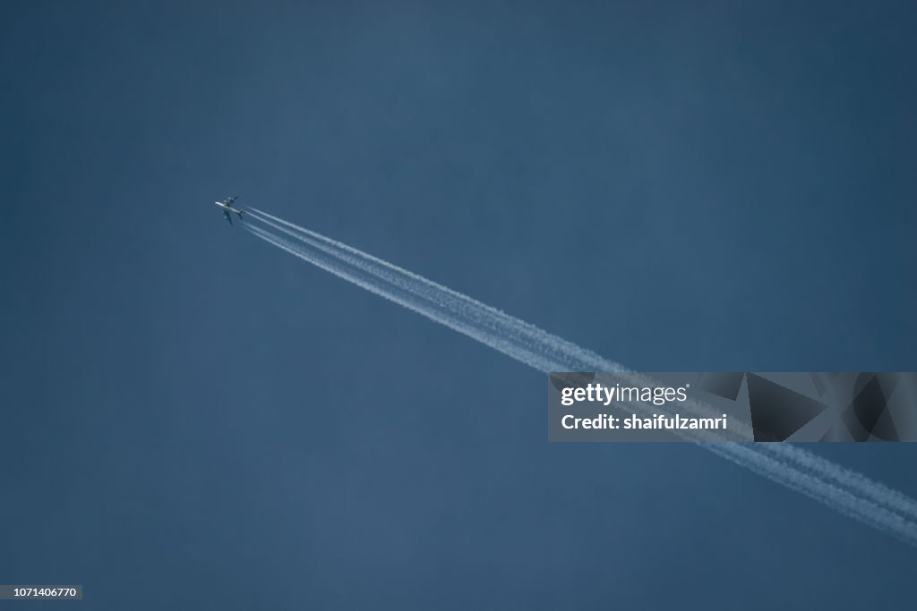 Contrails of flying aircraft above Kuala Lumpur