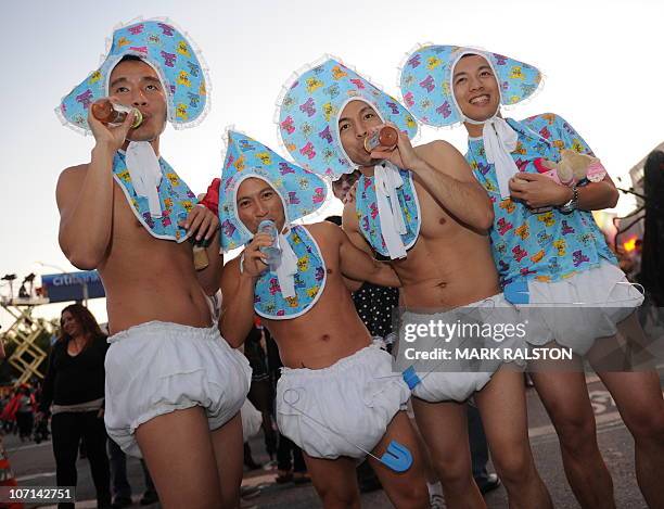 Men dressed as babies parade along Santa Monica Blvd during the annual Halloween Carnaval in West Hollywood on October 31, 2010. Organizers claim it...