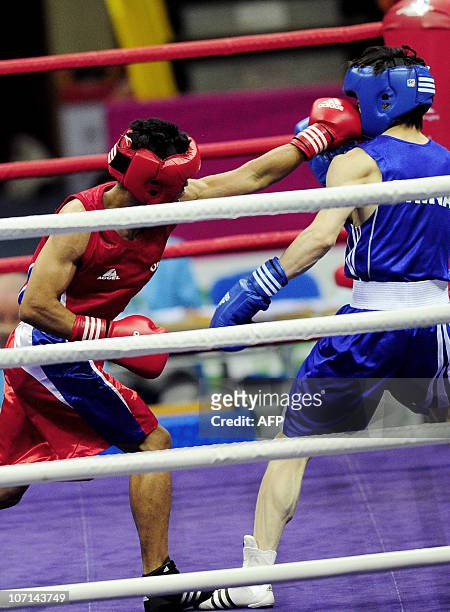 Rey Saludar of Philippines competes with Chang Yong of China during the men's -52kg boxing final competition at the 16th Asian Games in Guangzhou on...
