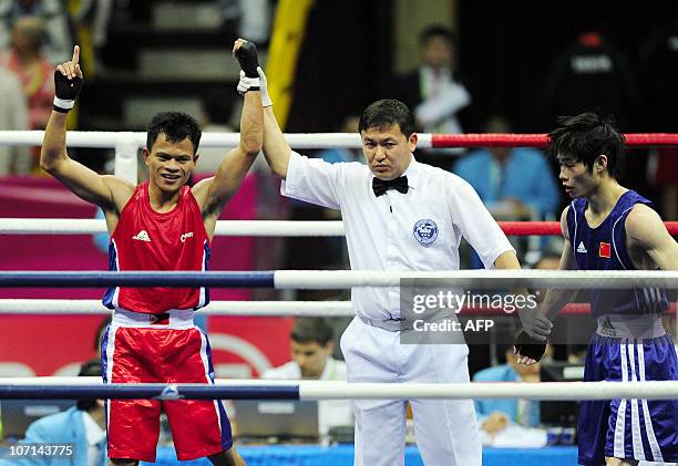 Rey Saludar of Philippines celebrates after beating Chang Yong of China during the men's -52kg boxing final competition at the 16th Asian Games in...