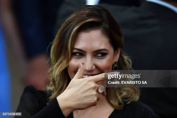 Michelle Bolsonaro gestures during a ceremony in which her husband Brazilian President-elect Jair Bolsonaro received a diploma that certifies he can...