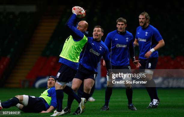 Wales player Martyn Williams in action as captain Matthew Rees looks on during Wales training at Millennium Stadium on November 25, 2010 in Cardiff,...