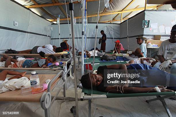 Cholera patients lay on cots as they are treated for cholera in a International Red Cross treatment facility in the slum neighborhood of Cite Soleil...