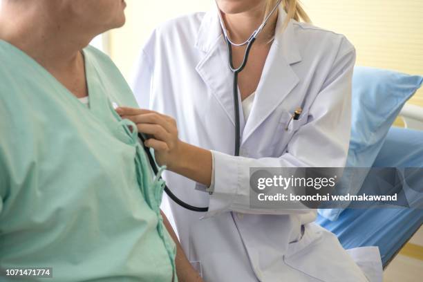 physical examination of the cardiovascular system with stethoscope of elderly man - heartbeat foto e immagini stock