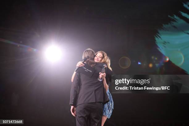 Cyrill Gutsch for Parley For The Oceans hugs award presenter Doutzen Kroes after receiving the Special Recognition Award for Innovation during The...