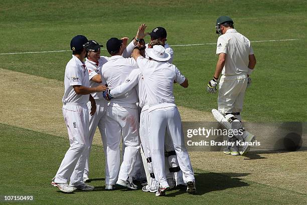Graeme Swann of England celebrates with team mates after taking the wicket of Marcus North of Australia during day two of the First Ashes Test match...