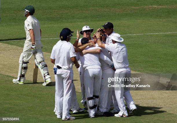 Graeme Swann of England celebrates with team mates after taking the wicket of Marcus North of Australia during day two of the First Ashes Test match...