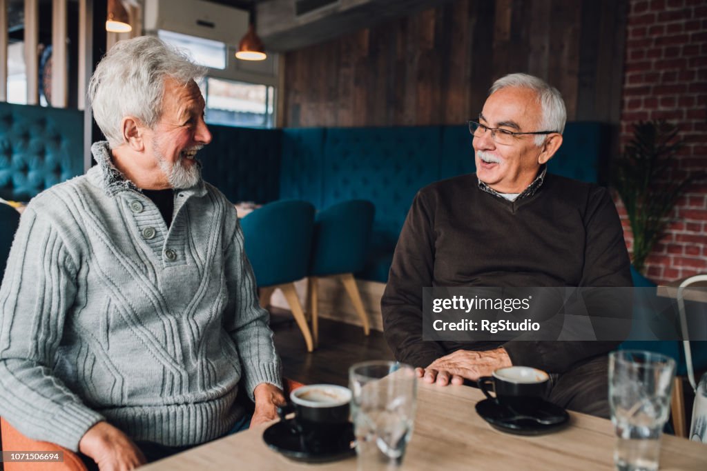 Happy mature men talking