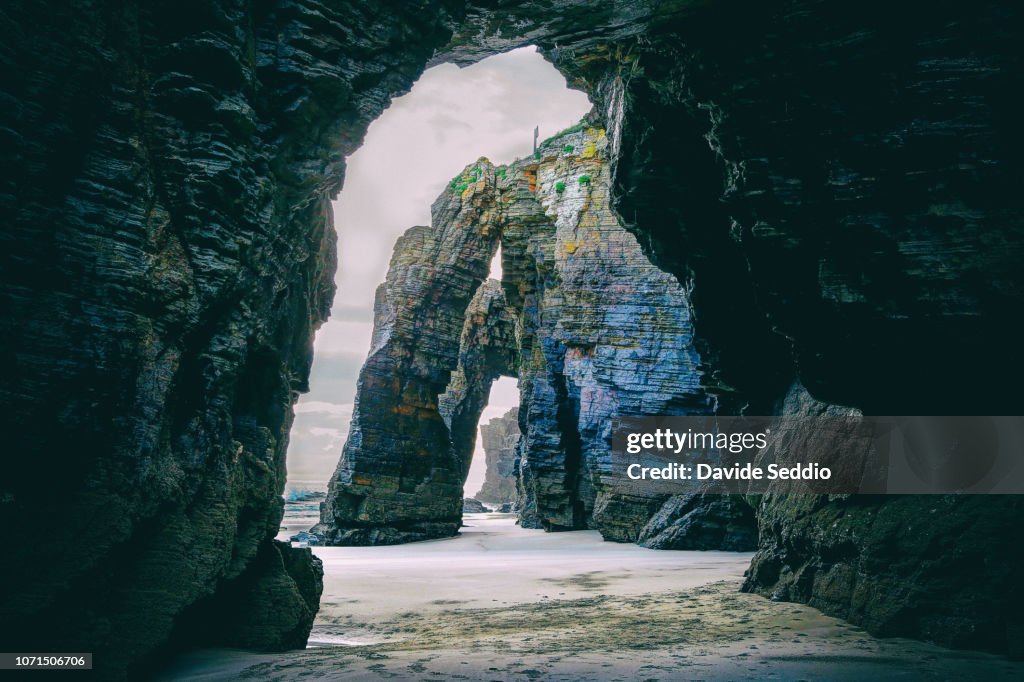 Natural arches during sunset on the beach of the cathedrals on the north Galician coastline