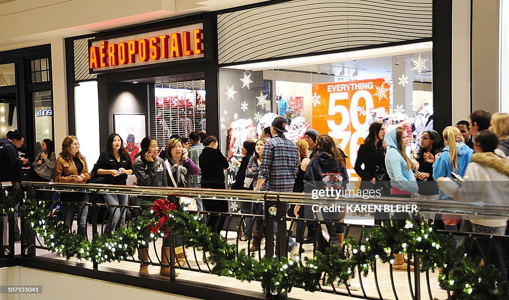 Shoppers wait to enter the Aeropostale s