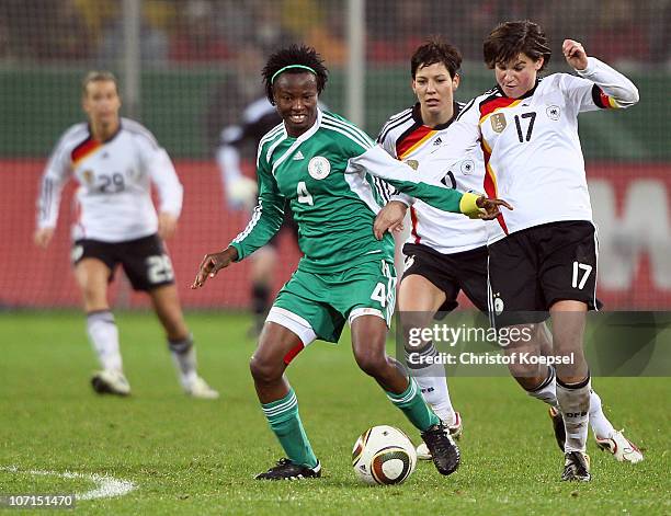 Ariane Hingst of Germany challenges Perpetua Ijeoma Nkwocha of Nigeria during the women's international friendly match between Germany and Nigeria at...