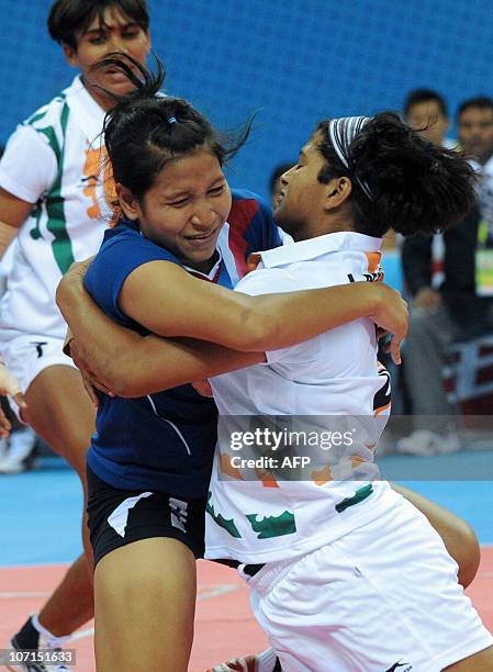 Deepika Henry Joseph of India takes down Cholada Chaiprapan of Thailand during the kabaddi women's final match at the 16th Asian Games in Guangzhou...