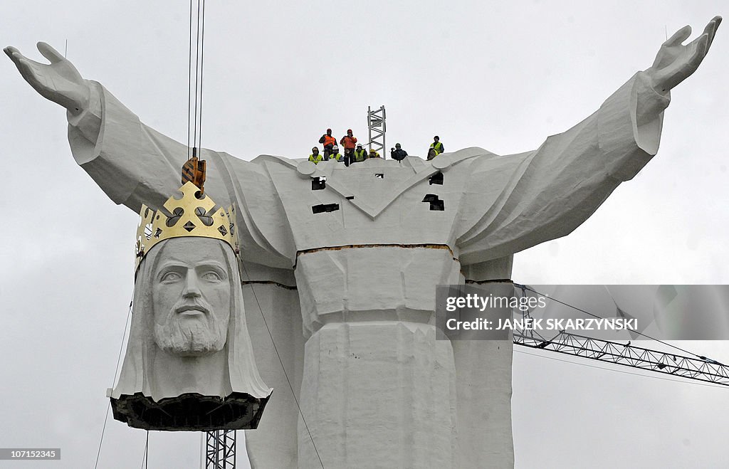 A crane lifts the head of what will be t