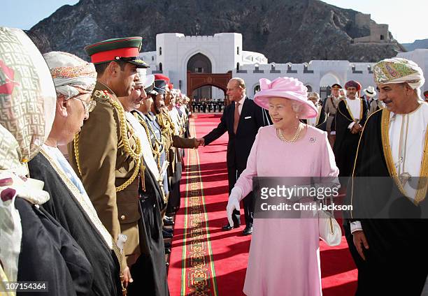 Queen Elizabeth II and Prince Philip, Duke of Edinburgh meet dignitaries as they visit Al-Alam Palace on November 26, 2010 in Muscat, Oman. Queen...