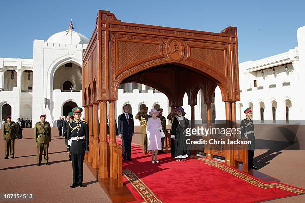 Queen Elizabeth II , Prince Philip, Duke of Edinburgh and Sultan Qaboos bin Said listen to the national anthem as they visit Al-Alam Palace on...