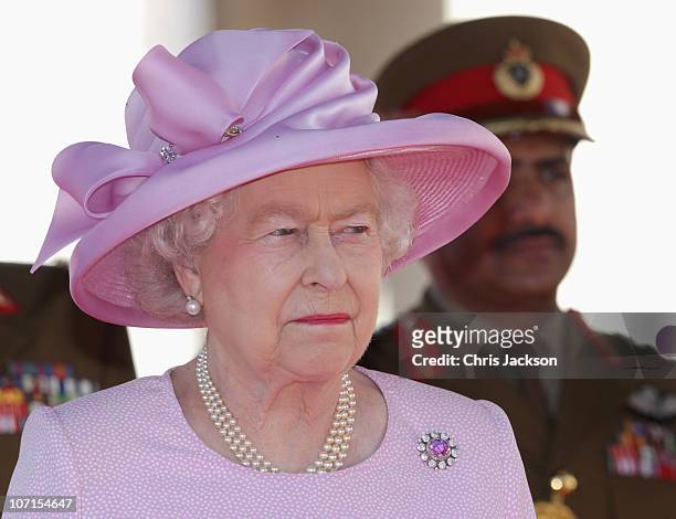 Queen Elizabeth II takes a salute as she visits Al-Alam Palace on November 26, 2010 in Muscat, Oman. Queen Elizabeth II and Prince Philip, Duke of...