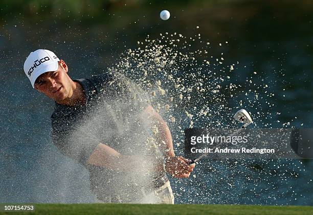 Martin Kaymer of Germany plays a bunker shot on the 17th hole during the second round of the Dubai World Championship on the Earth Course, Jumeirah...