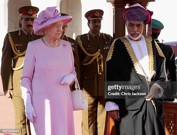 Queen Elizabeth II and Sultan Qaboos bin Said take the salute at Al-Alam Palace on November 26, 2010 in Muscat, Oman. Queen Elizabeth II and Prince...