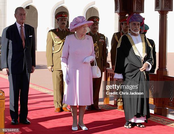 Prince Philip, Duke of Edinburgh, Queen Elizabeth II and Sultan Qaboos bin Said take the salute at Al-Alam Palace on November 26, 2010 in Muscat,...