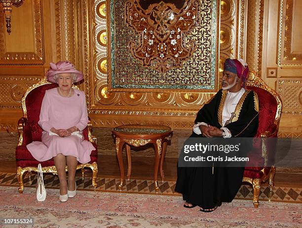 Queen Elizabeth II poses for a photograph with Sultan Qaboos bin Said as she visits Al-Alam Palace on November 26, 2010 in Muscat, Oman. Queen...