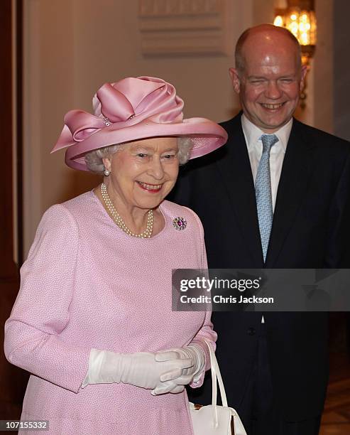 Queen Elizabeth II laughs with Foreign & Commonwealth Secretary William Hague during a Tate Gallery event as they visit Al-Alam Palace on November...