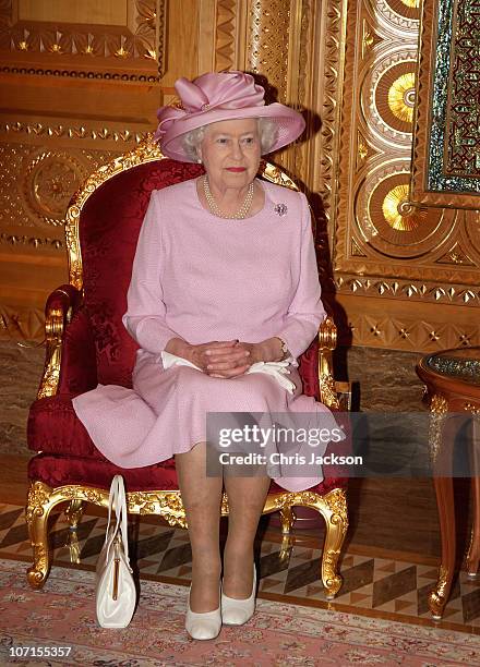 Queen Elizabeth II poses for a photograph with Sultan Qaboos bin Said as she visits Al-Alam Palace on November 26, 2010 in Muscat, Oman. Queen...