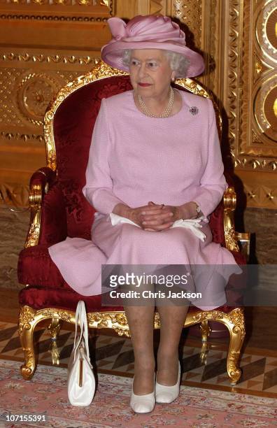 Queen Elizabeth II poses for a photograph with Sultan Qaboos bin Said as she visits Al-Alam Palace on November 26, 2010 in Muscat, Oman. Queen...