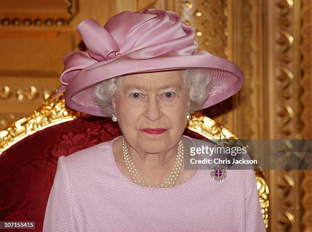 Queen Elizabeth II poses for a photograph as she visits Sultan Qaboos bin Said at Al-Alam Palace on November 26, 2010 in Muscat, Oman. Queen...