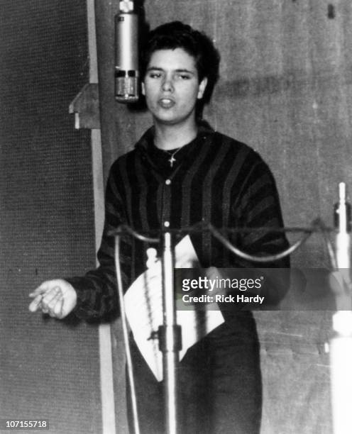 Cliff Richard sings at the microphone during the recording of his single 'Livin' Doll' at Abbey Road Studios on 28th April 1958 in London.