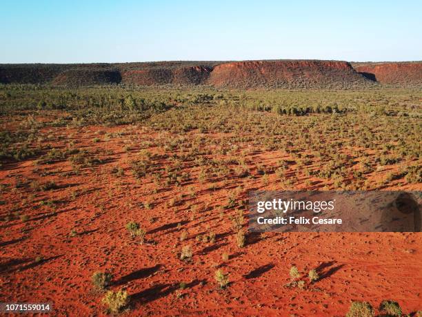 an aerial shot of the red centre roads in the australian outback - kings canyon fotografías e imágenes de stock