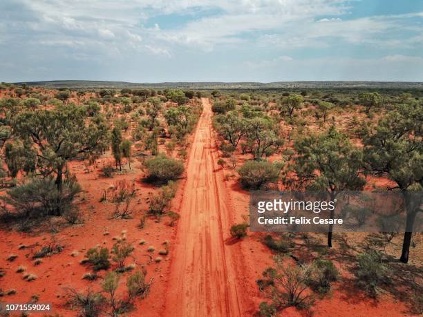 an aerial shot of the red centre roads in the australian outback - aussie stockfoto's en -beelden