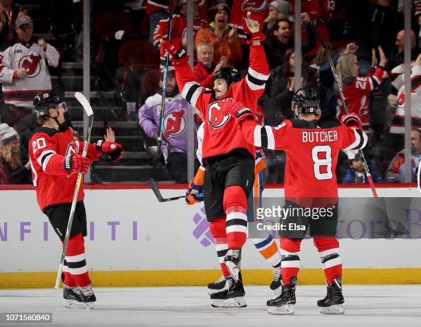 Brian Boyle of the New Jersey Devils celebrates his goal with teammates Blake Coleman and Will Butcher in the third period against the New York...