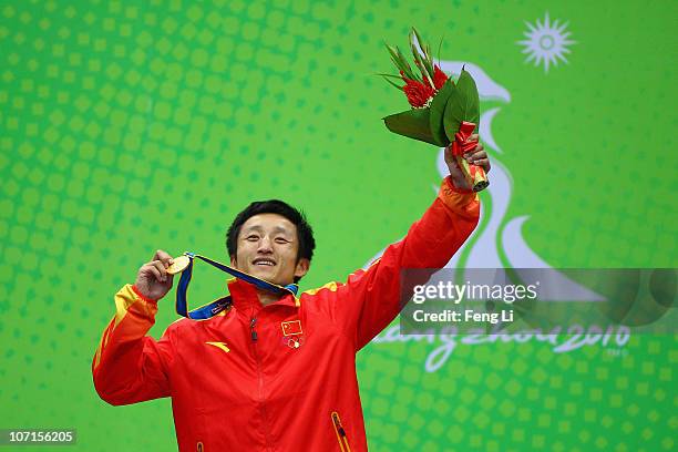 Zou Shiming of China celebrates winning gold during the medal ceremony of the Men's 46-49kg match at Foshan Gynasium during day fourteen of the 16th...