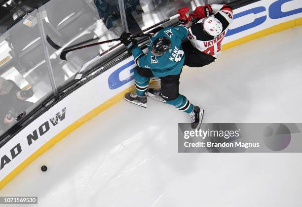 An overhead as Evander Kane of the San Jose Sharks collides with Sami Vatanen of the New Jersey Devils at SAP Center on December 10, 2018 in San...