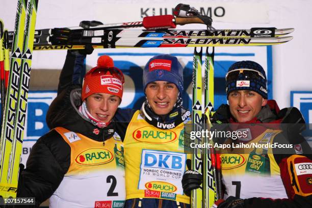 Eric Frenzel of Germany, Jason Lamy Chappuis of France and Mario Stecher of Austria pose on the podium after the Gundersen Ski Jumping HS 142/10km...