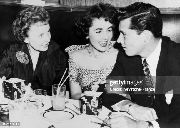 At the Stork Club, film actress Liz Taylor and her fiance Conrad N.Hilton, son of a wealthy hotel magnate, and ,Liz's mother Sara on March 16, 1950...