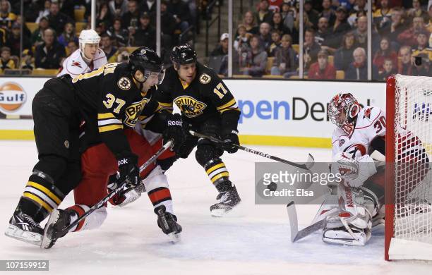 Cam Ward of the Carolina Hurricanes stops a shot by Patrice Bergeron of the Boston Bruins on November 26, 2010 at the TD Garden in Boston,...
