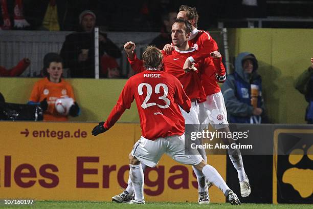 Nikolce Noveski of Mainz celebrates his team's second goal with team mates Marcel Risse and Niko Bungert during the Bundesliga match between FSV...