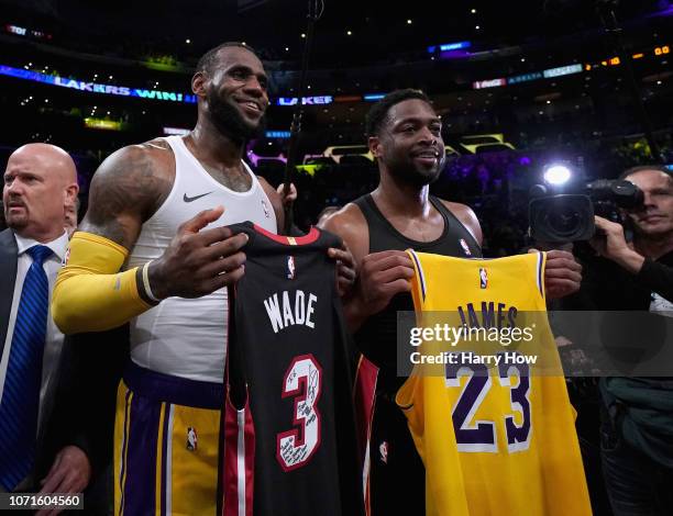 LeBron James of the Los Angeles Lakers and Dwyane Wade of the Miami Heat pose for a photo after exchanging jerseys, as Wade plans to retire at the...