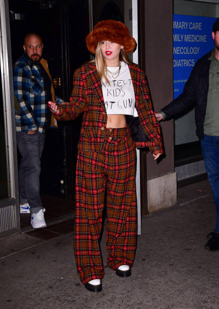 Miley Cyrus leaves Electric Lady Studios wearing a t-shirt saying "Protect kids not guns" on December 10, 2018 in New York City.