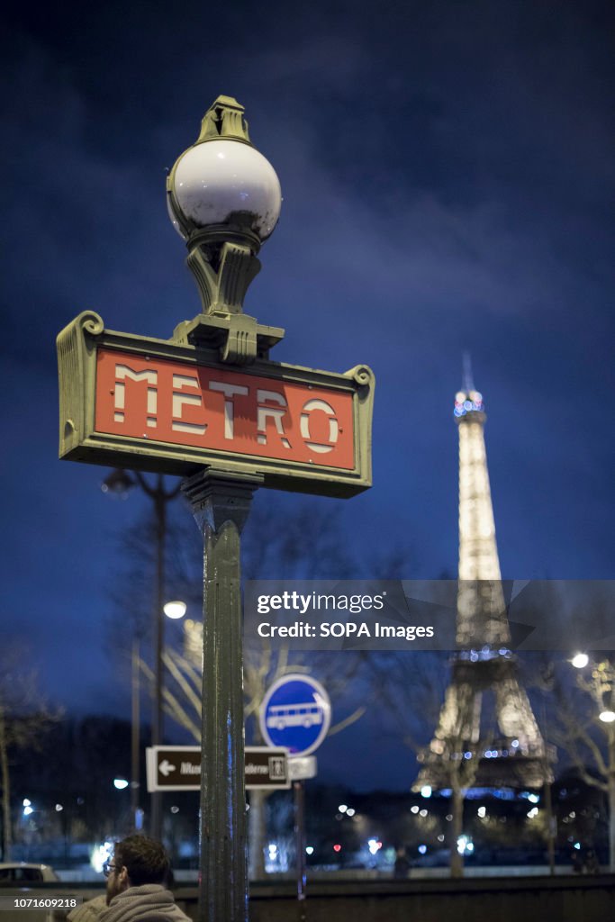 Eiffel Tower illuminated seen in the night with a Metro...