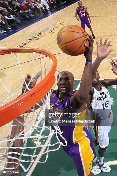 Lamar Odom of the Los Angeles Lakers goes for the layup against Francisco Elson of the Utah Jazz at EnergySolutions Arena on November 26, 2010 in...