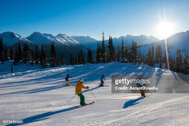 skiing in the mountains on a perfect day - friends skiing stock pictures, royalty-free photos & images