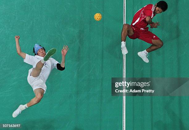 Jun Ho Lee of Korea trys to kick the ball past Aung Zaw Zaw of Myanmar during the Sepaktakraw Mens Double final between Korea and Myanmar at...