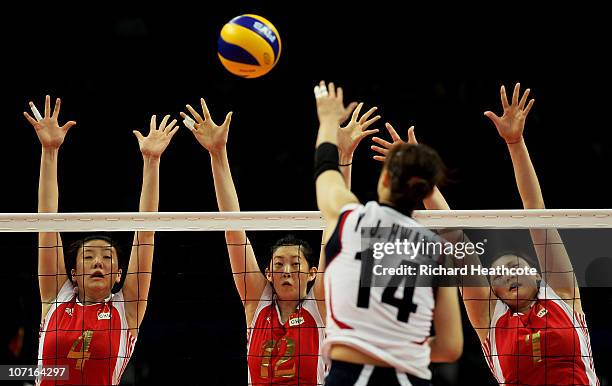 Jingsi Shen, Ming Xue and Xian Zhang of China go up for the ball against Youn Joo Hwang of South Korea in the second set during the Women's Gold...