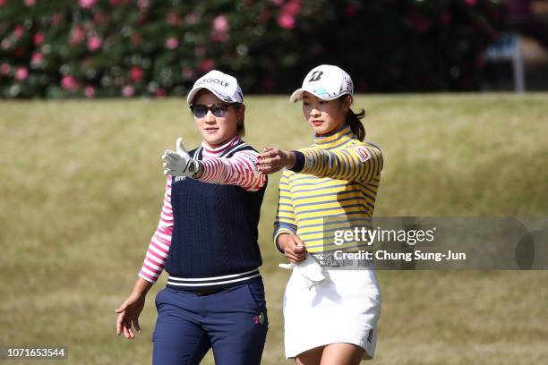 Misuzu Narita of Japan talks with Rei Matsuda of Japan on the 15th hole during the third round of the LPGA Tour Championship Ricoh Cup at Miyazaki...