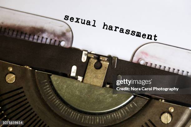 sexual harassment typed on vintage typewriter - story telling in the workplace stock pictures, royalty-free photos & images