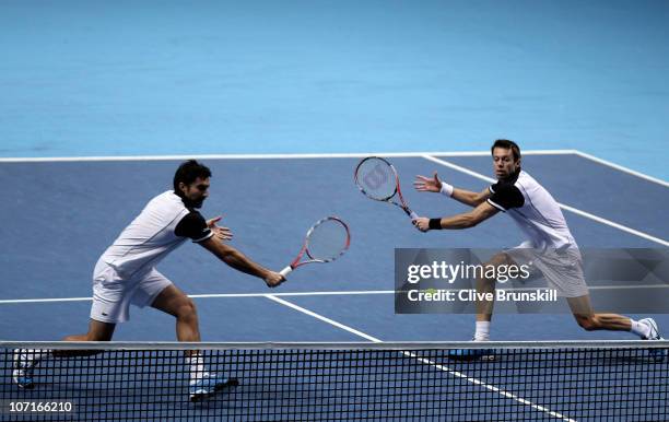 Daniel Nestor of Canada and Nenad Zimonjic of Serbia eye the ball during their men's double semi-final match against Mike Bryan and Bob Bryan of the...