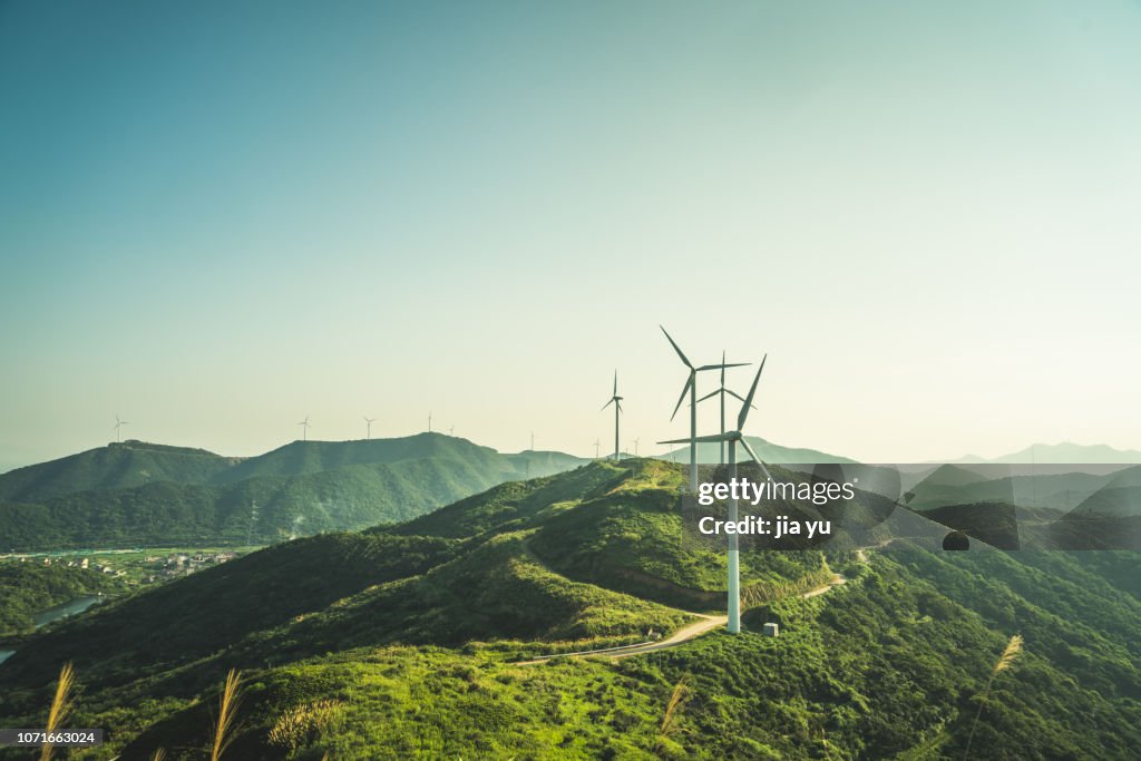 Large group of wind turbines on the mountain near by sea