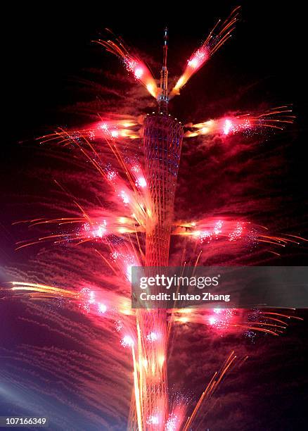 Fireworks are seen off the Canton Tower during the Closing Ceremony at Haixinsha Square on day fifteen of the 16th Asian Games Guangzhou 2010 on...